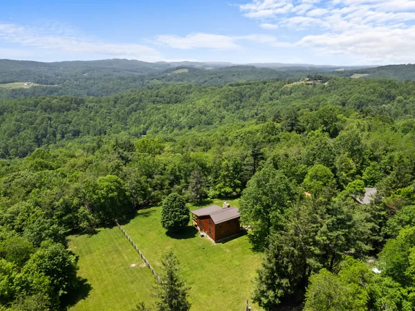 Drone aerial of a vacation rental property and its mountain setting